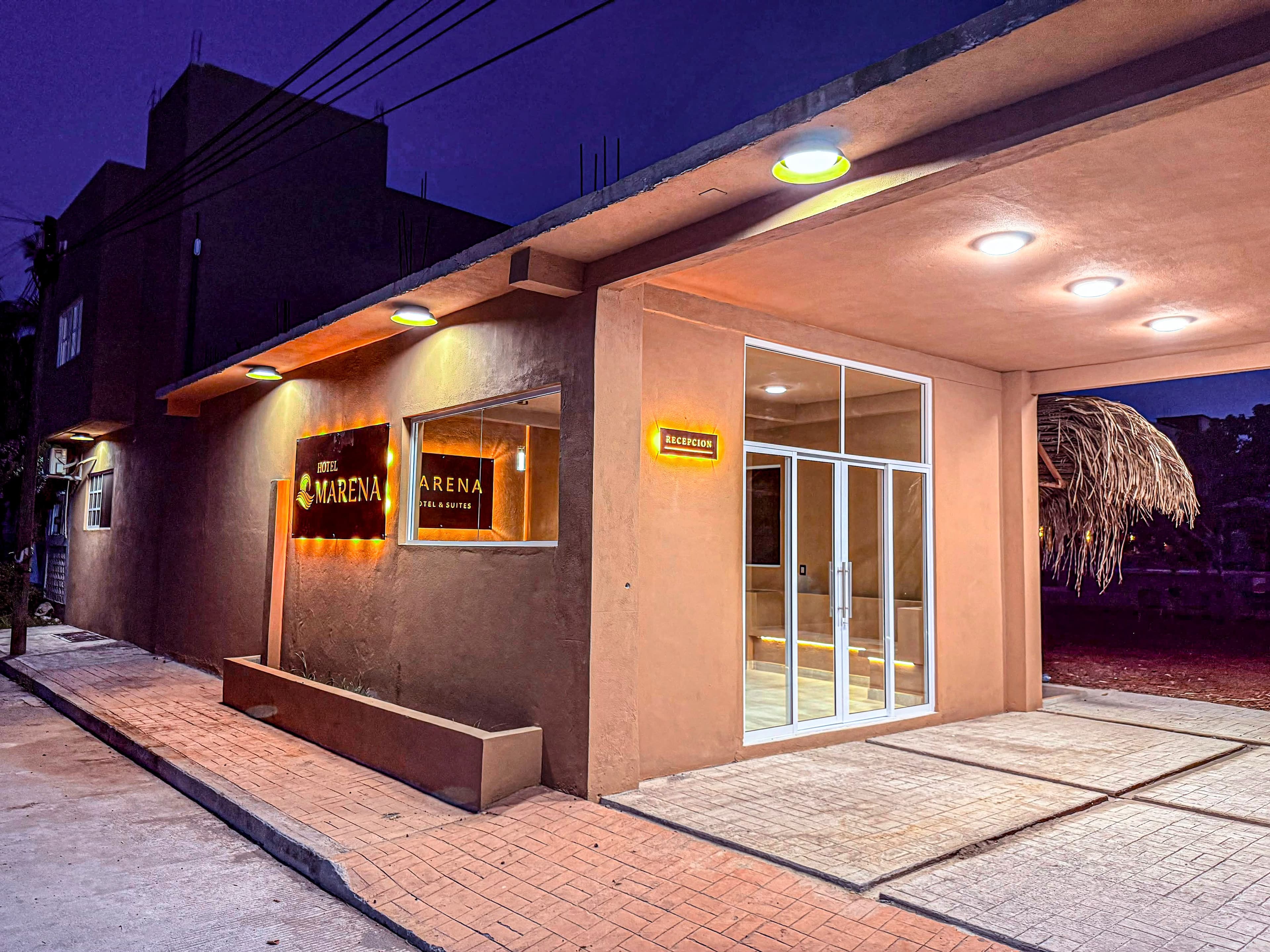 Recepción de Hotel Marena iluminada de noche